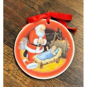 1984 The Kneeling Santa annual glass ornament.
